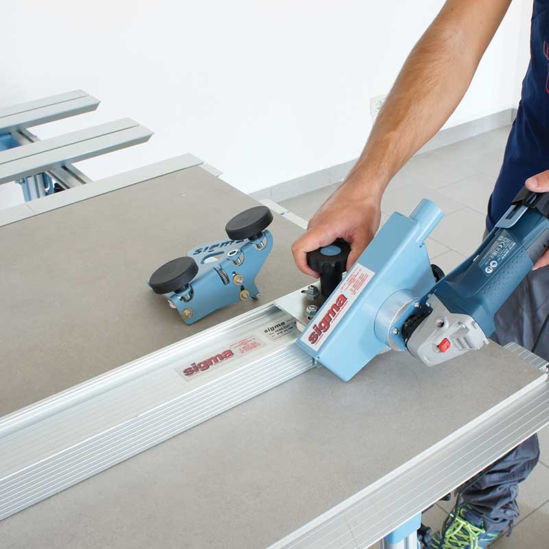 Person using a power tool on a workbench with 'Sigma' branding.