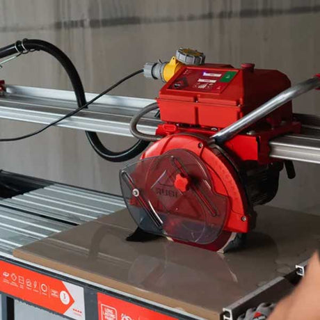 Red tile cutter on a table with a blurred background